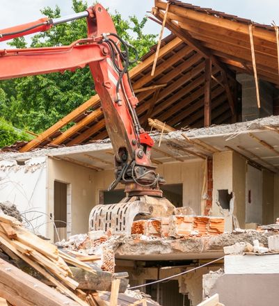 Excavator demolishing an old structure in Upstate South Carolina
